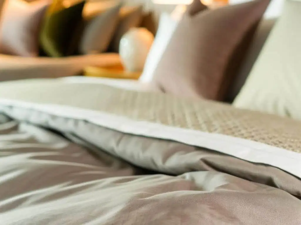 Inserting duvet cover on bed